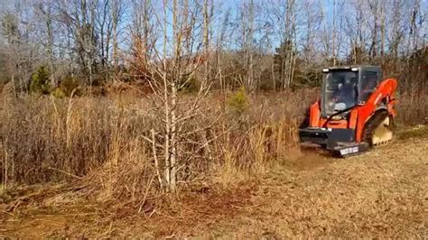 removing small trees and brush with skid steer|heavy brush clearing equipment.